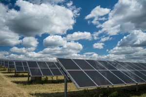 Solar panels used for renewable energy on the field under the sky full of clouds